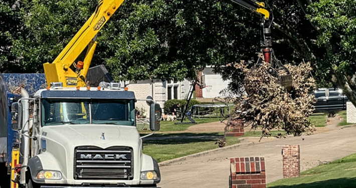 Waste Connections truck picking up bulky brush.