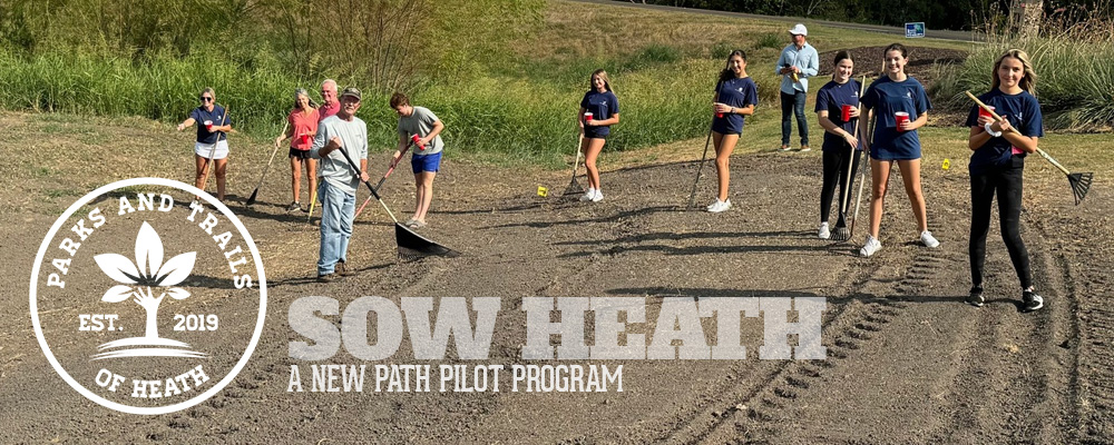 Volunteers planting Bluebonnet seeds in Heath Crossing.